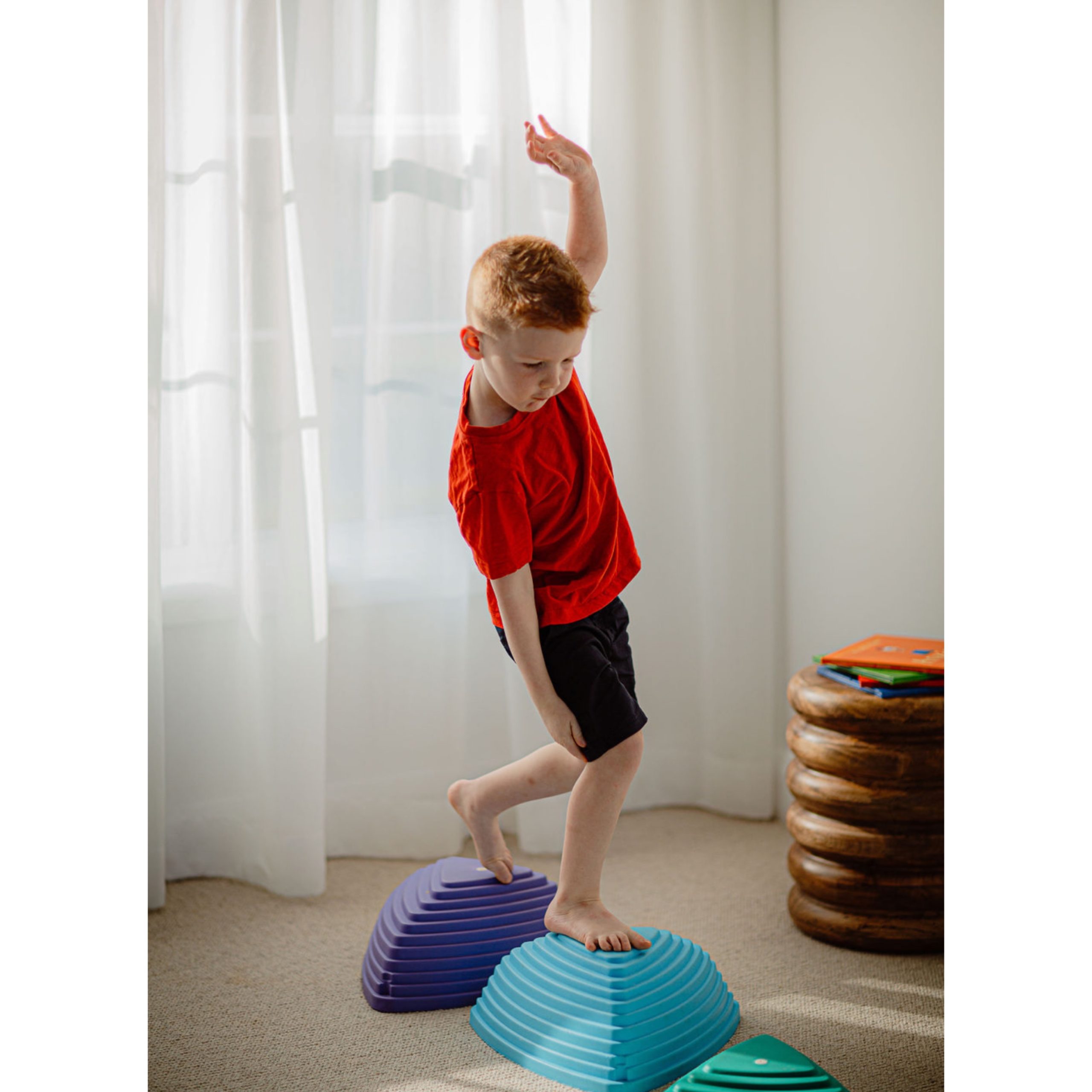 Photo of a young boy walking on an obstacle course as part of occupational therapist